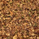 Picture of golden honey granola on a sheet pan.