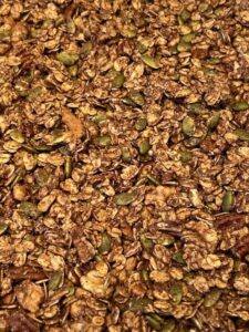 Picture of golden honey granola on a sheet pan.