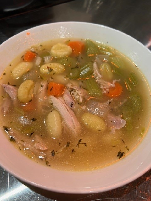 Picture of a bowl of chicken gnocchi noodle soup.