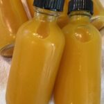 Picture of lemon turmeric ginger wellness shots in bottles.