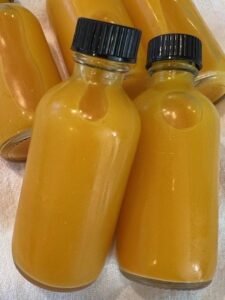 Picture of lemon turmeric ginger wellness shots in bottles.