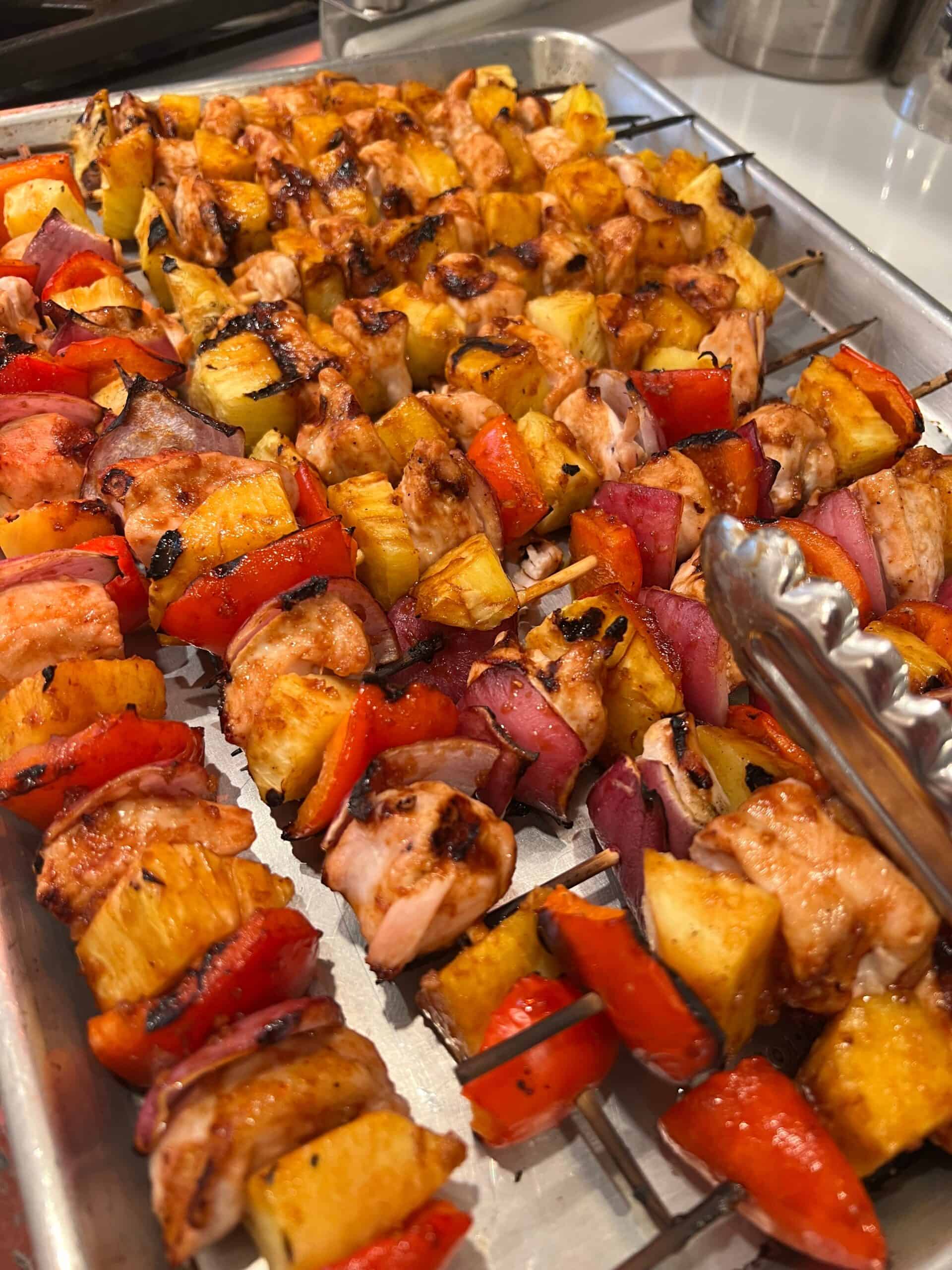 Pineapple Chicken Kabobs grilled on a sheet plan.