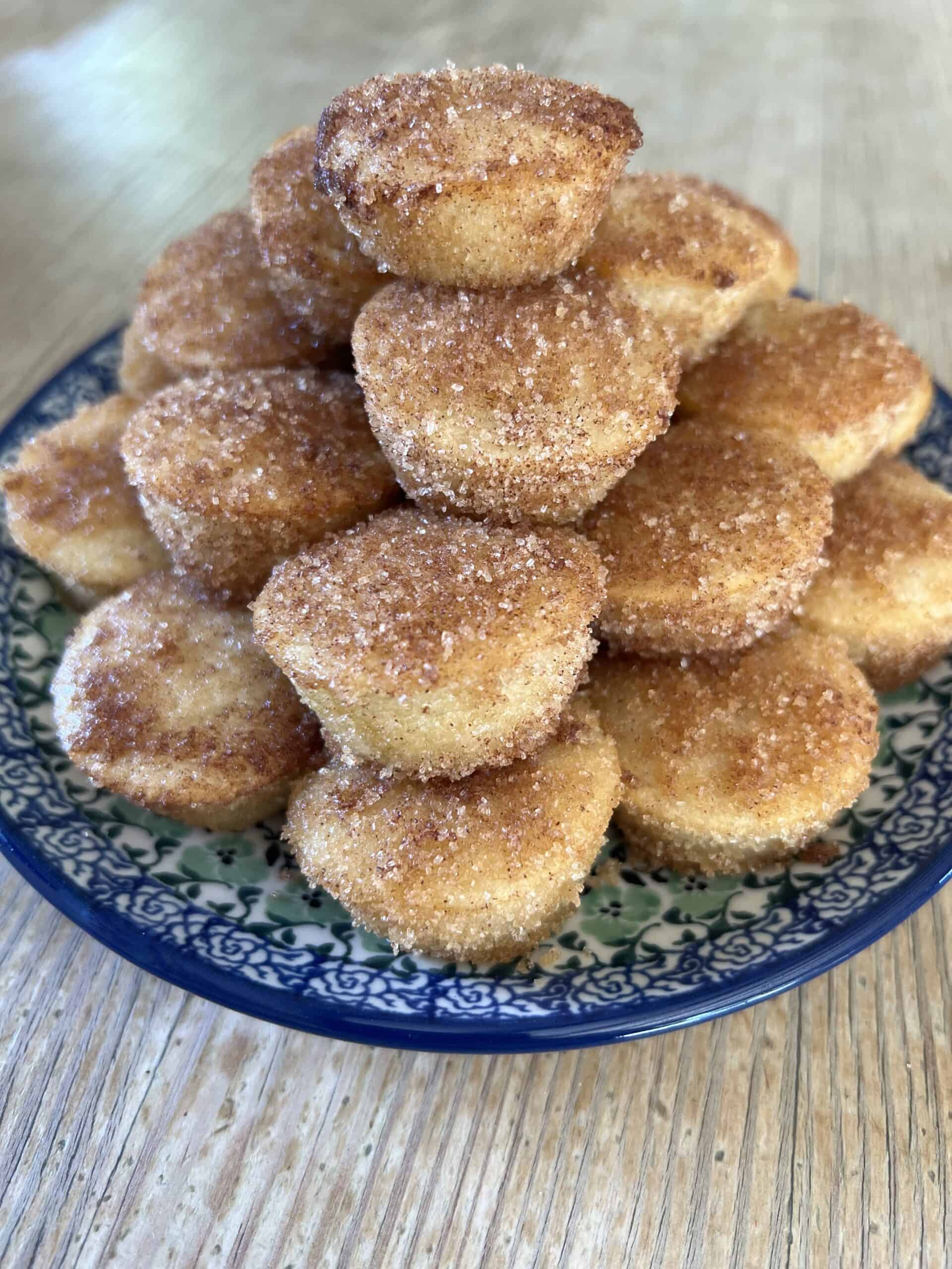 Picture of a plate of Baked Apple Cinnamon Doughnut Holes on a blue plate.